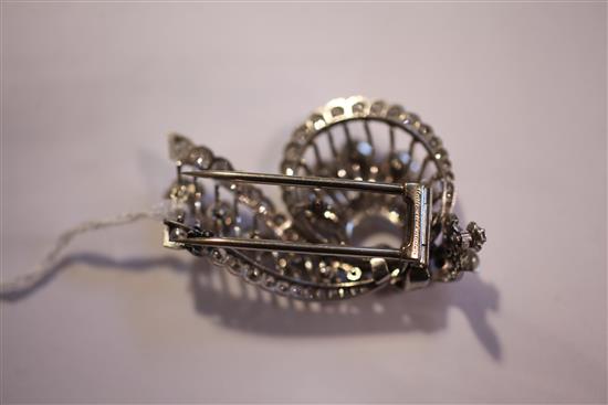 A 1950s Cartier platinum and diamond clip brooch, approx. 2in.
